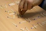Hand playing with matches
